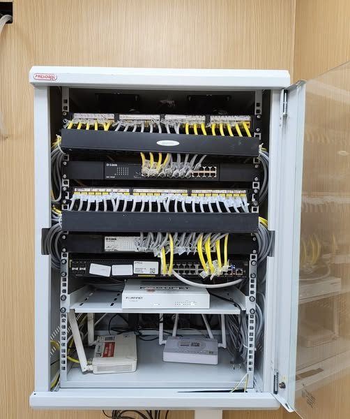 Wall-mount network rack with patch panels and security appliance installed by RITE Solutions