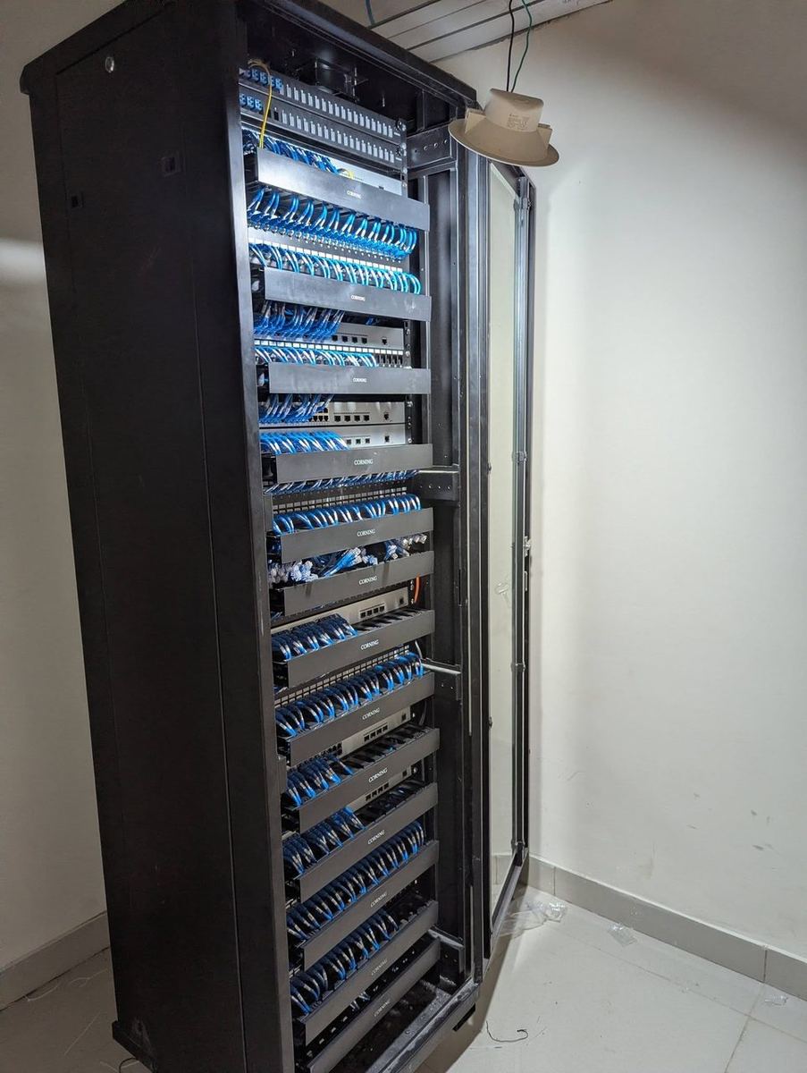 Full-height server rack with organized cable management by RITE Solutions